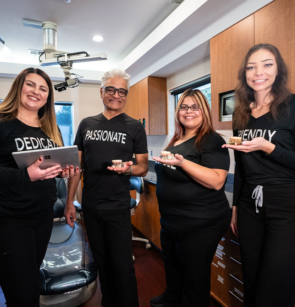 dr alijanian's a team smiling in procedure room of office
