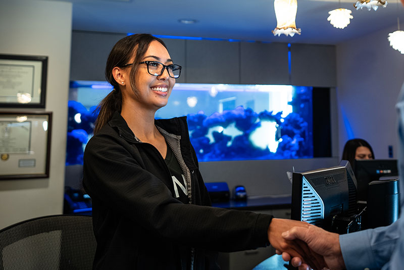 front desk consult shaking hands