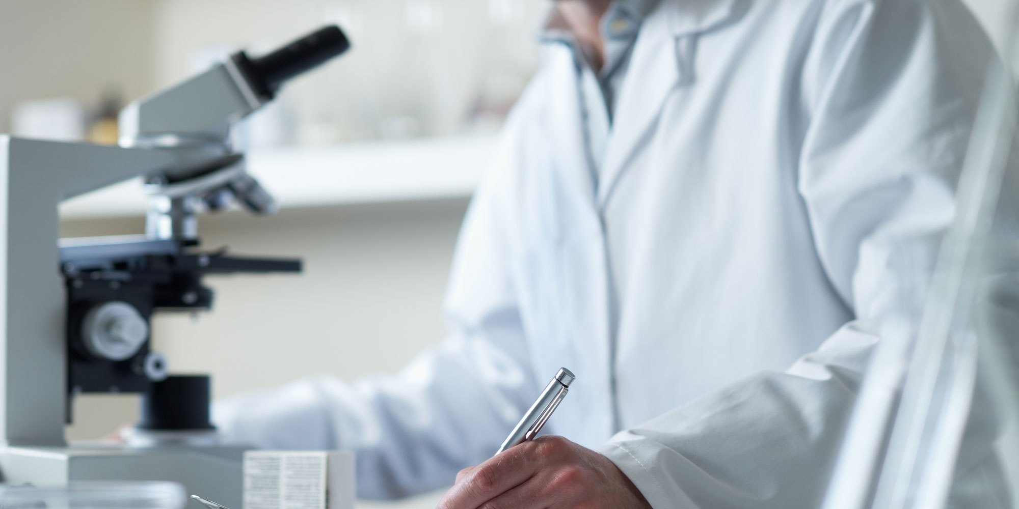 dentist examing sample collected from dental patient